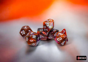 Set of polyhedral dice with red and brown colors on a blurred background